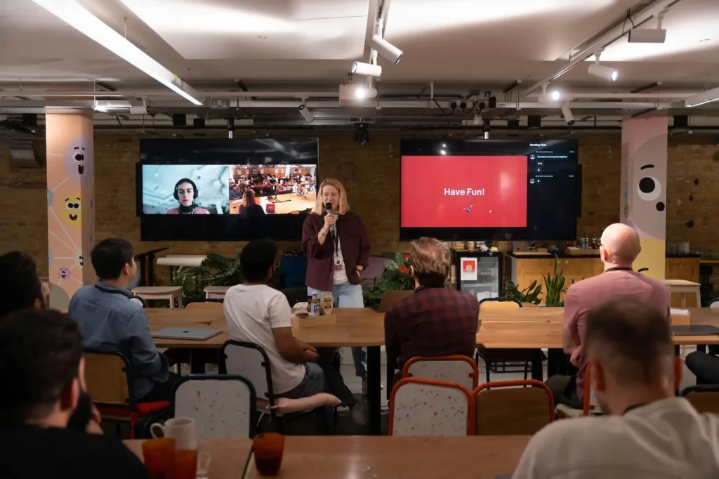 Speaker presenting using digital signage screens at business event