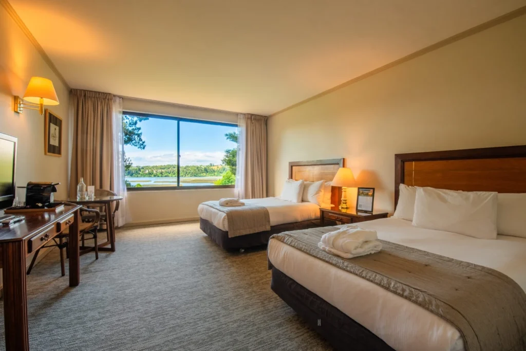 Modern hotel room interior with beds and window view