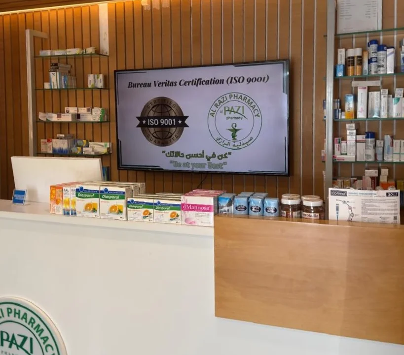 Pharmacy counter with digital signage screen displaying certification and branding