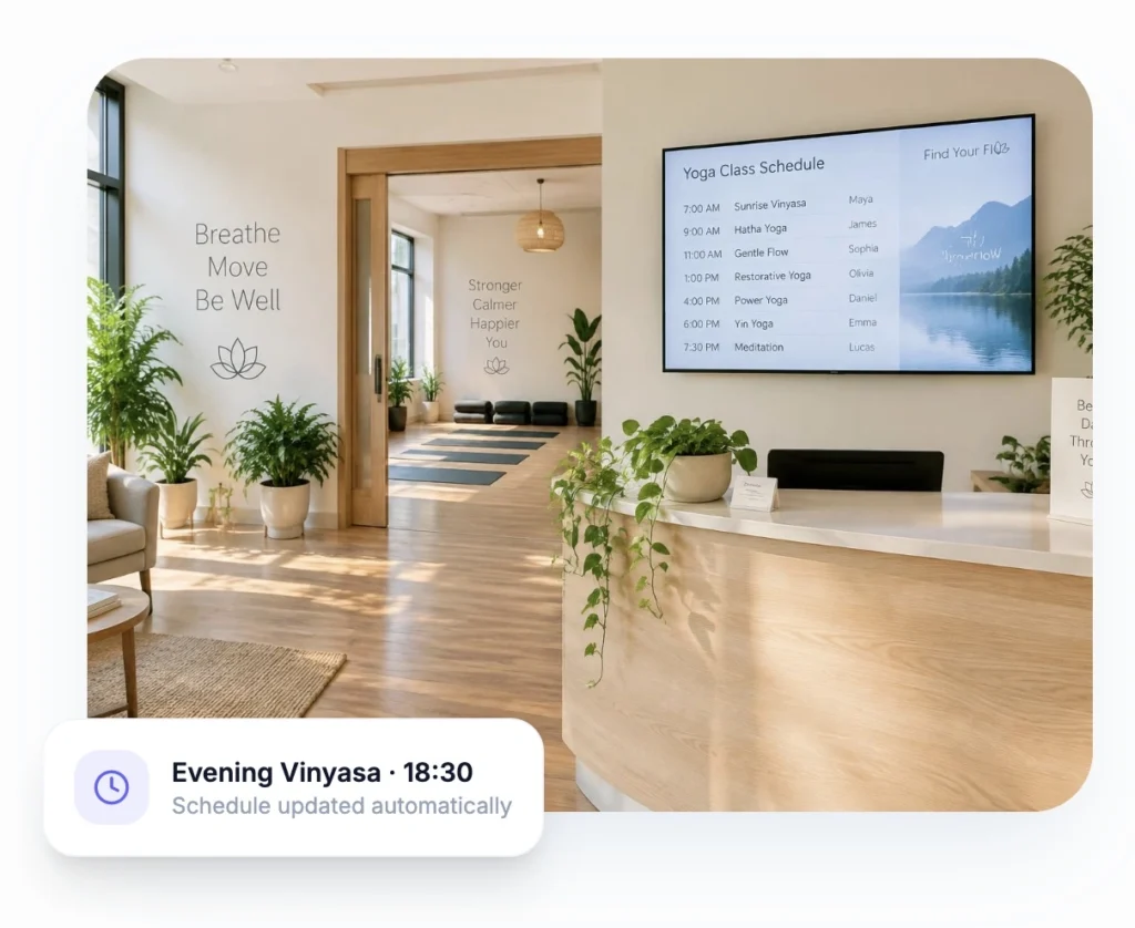 Modern yoga studio reception with a digital class schedule, natural wood interiors, indoor plants, yoga mats, and an Evening Vinyasa class notification.